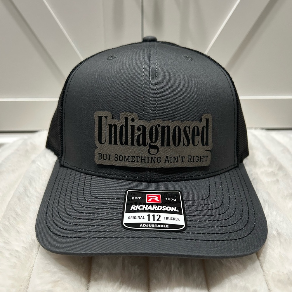 Undiagnosed, but something ain’t right. Laser engraved Richardson trucker hat.